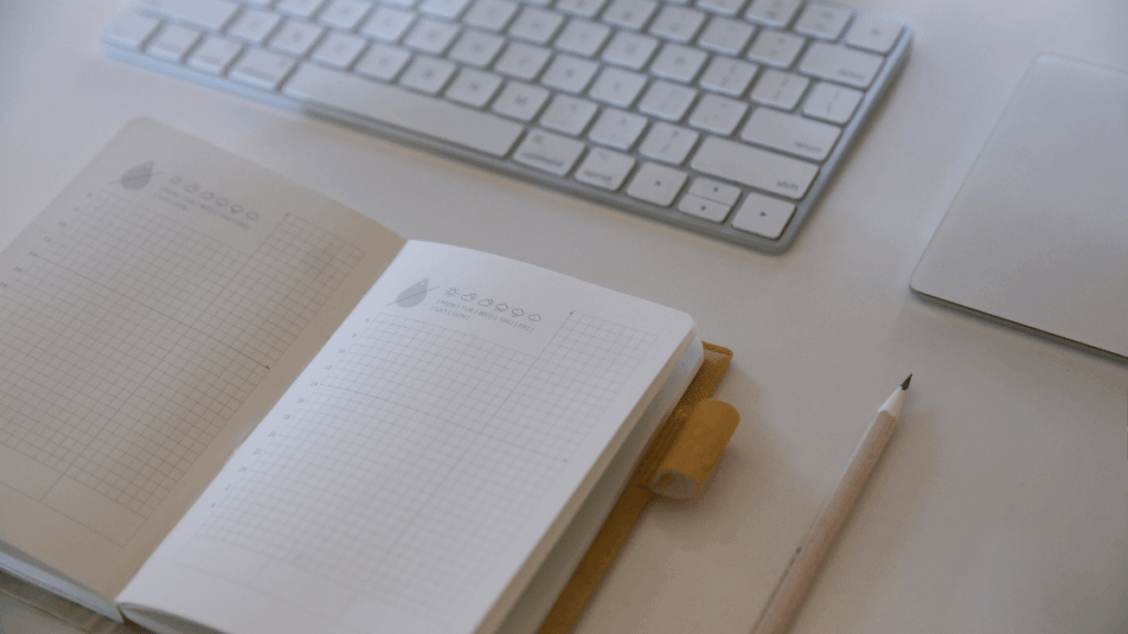 Homeowner reviewing floor plans and taking notes while planning a home remodeling project.